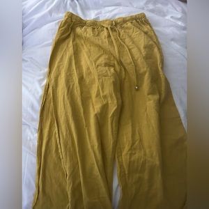 Cute yellow high-waisted flowy pants with a slit down the side